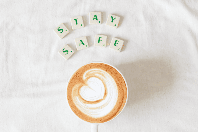 Stay safe letters over a coffee cup