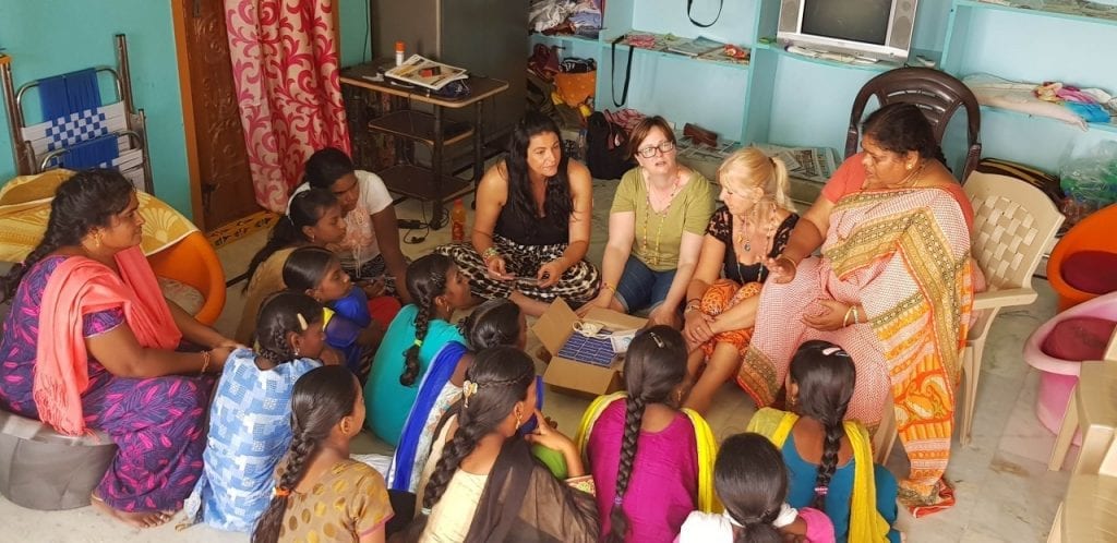 Mooncup menstrual cup being delivered with menstrual hygiene management to a group of women and girls