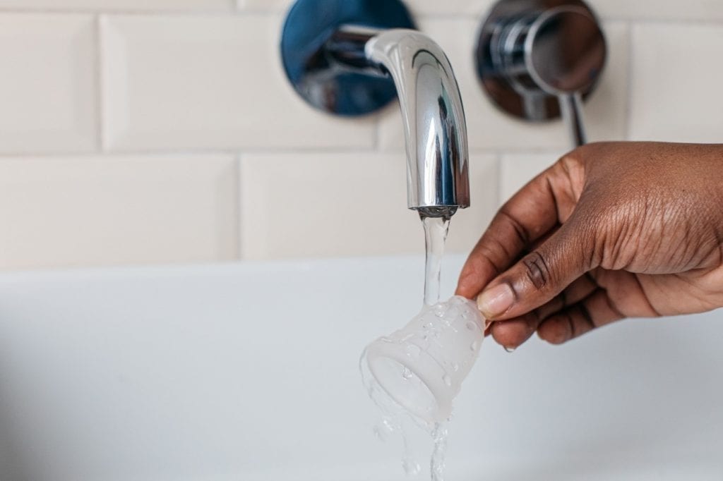 Washing the Mooncup Menstrual Cup under a tap - good menstrual cup hygiene 